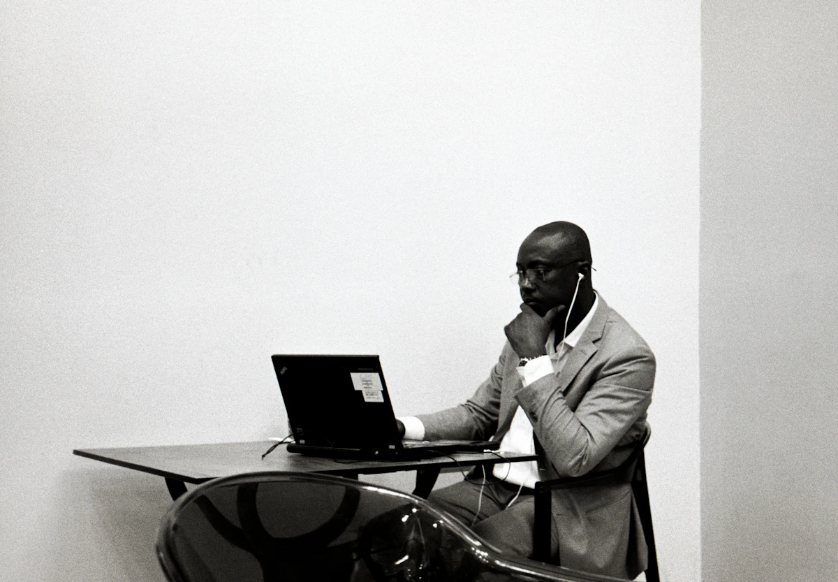 Black IT specialist testing AI tools on a computer in an East African tech office