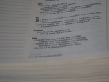 A close-up view of a page from a book containing poetic text with sections labeled 'She,' 'He,' and 'Friends.' The text is printed in clear black font on a white page.