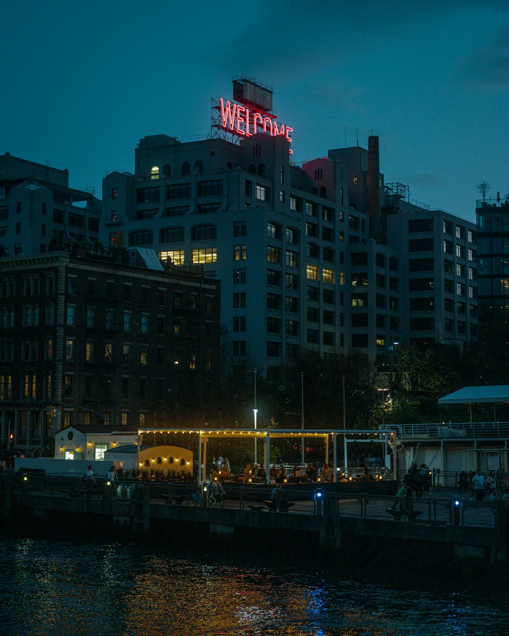 a building with a sign on it by a body of water