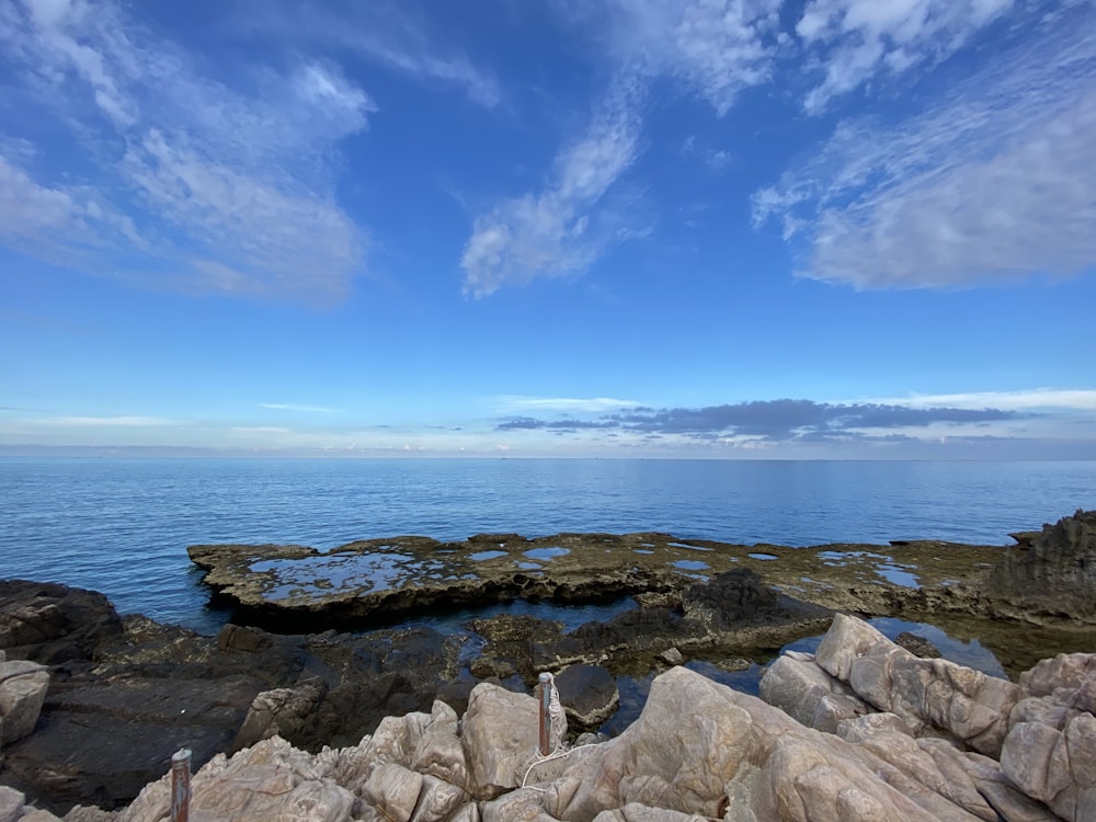 a rocky beach with blue water