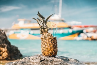 A tropical setting featuring pineapples filled with refreshing drinks.