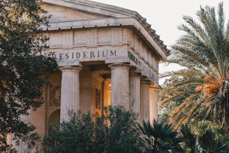 a building with columns and trees