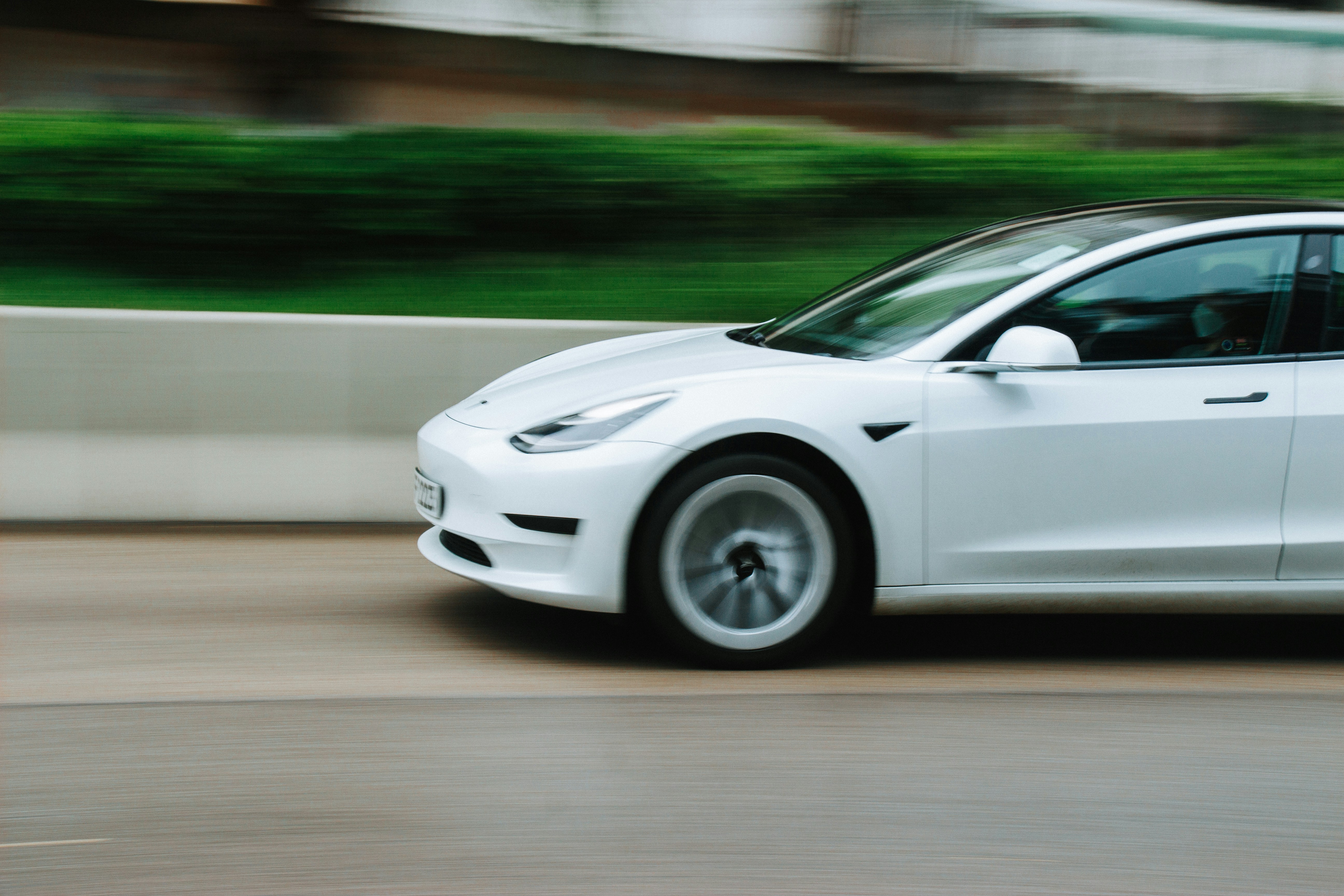 Tesla Model X driving on the highway, illustrating everyday use and maintenance needs