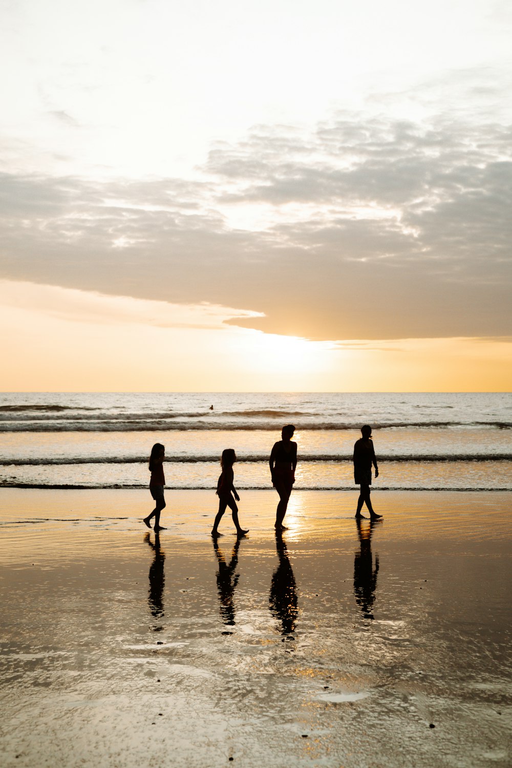 a group of people walking on a beach