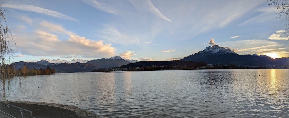 a body of water with mountains in the background