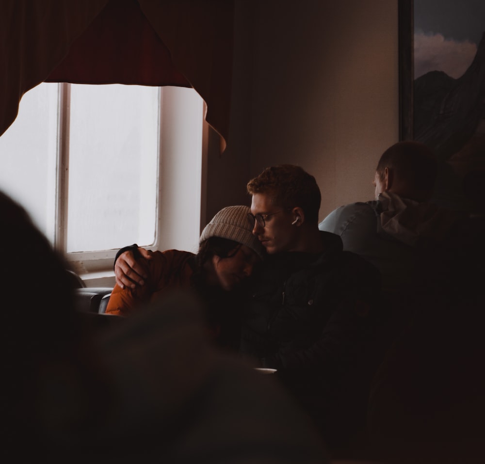 a group of people sitting in a dark room