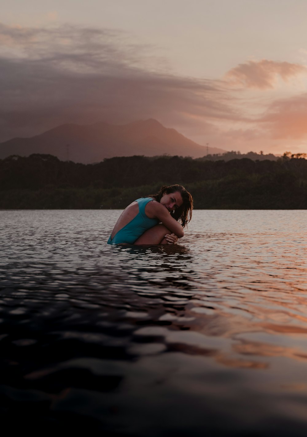 a woman hugging a man in a body of water