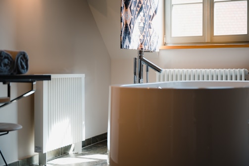 a room with a white heater and beautifull bathtub