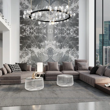 A contemporary living room showcasing a geometric chandelier, a low-profile sofa with patterned cushions, and a wooden coffee table with ceramic accents.