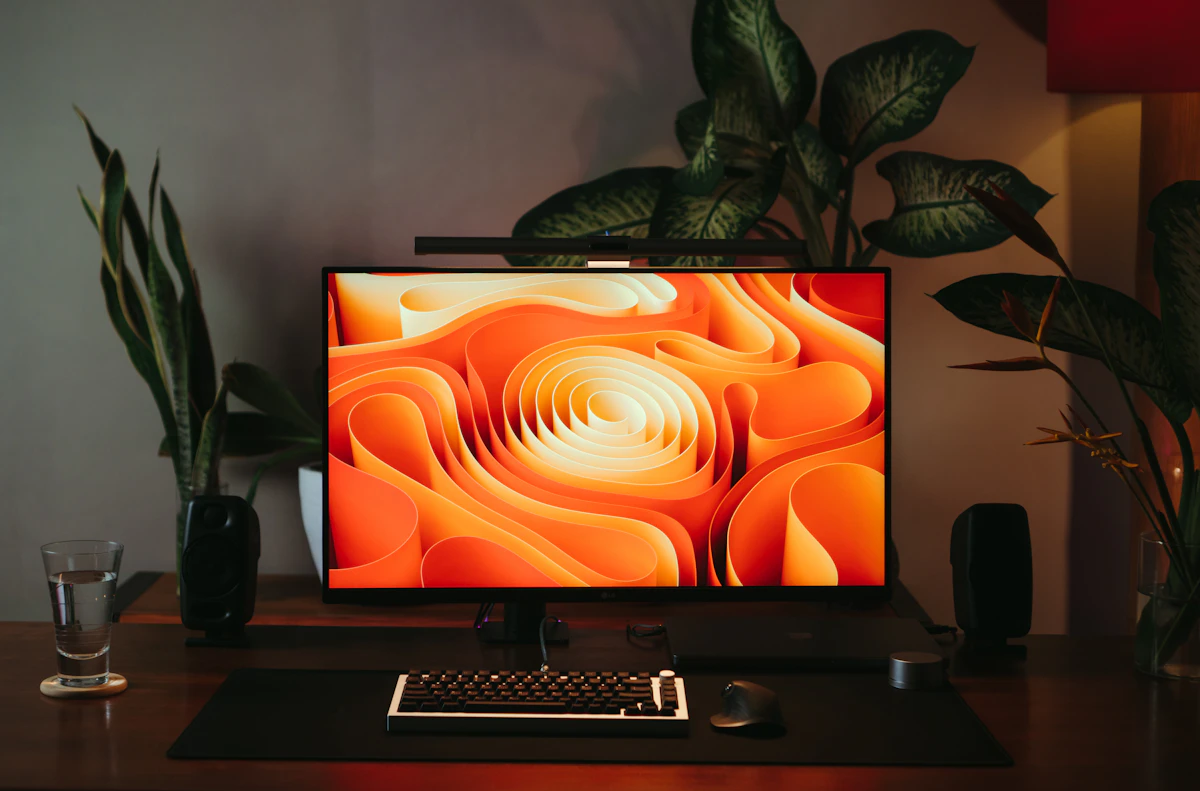 A computer with a glowing screen in a dark room