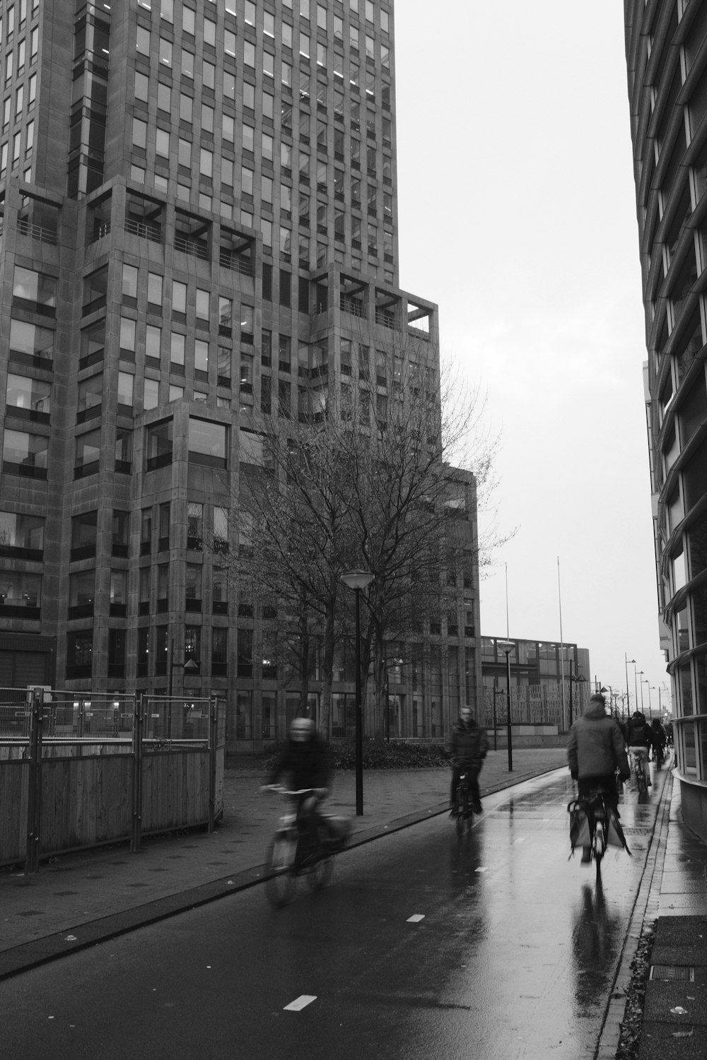 a group of people walking on a sidewalk next to a building