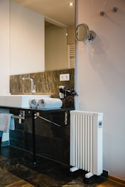Close-up of a new water heater installation in a modern bathroom.