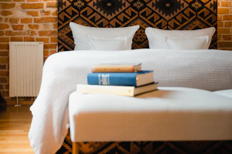 a bed with books on it