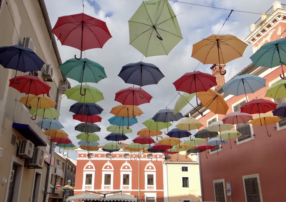 a group of umbrellas are from a building