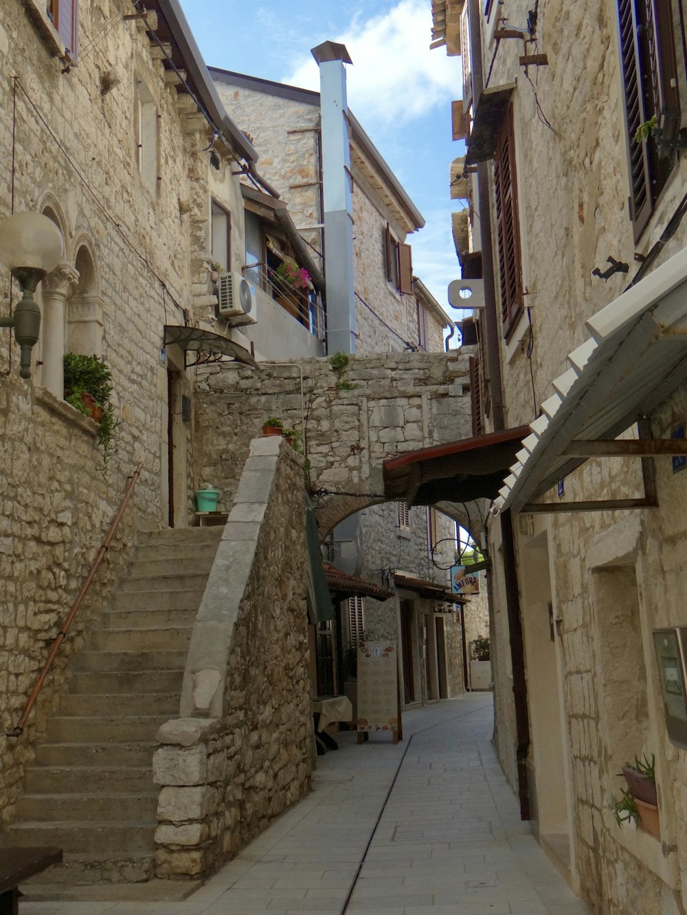 a narrow street with stone buildings