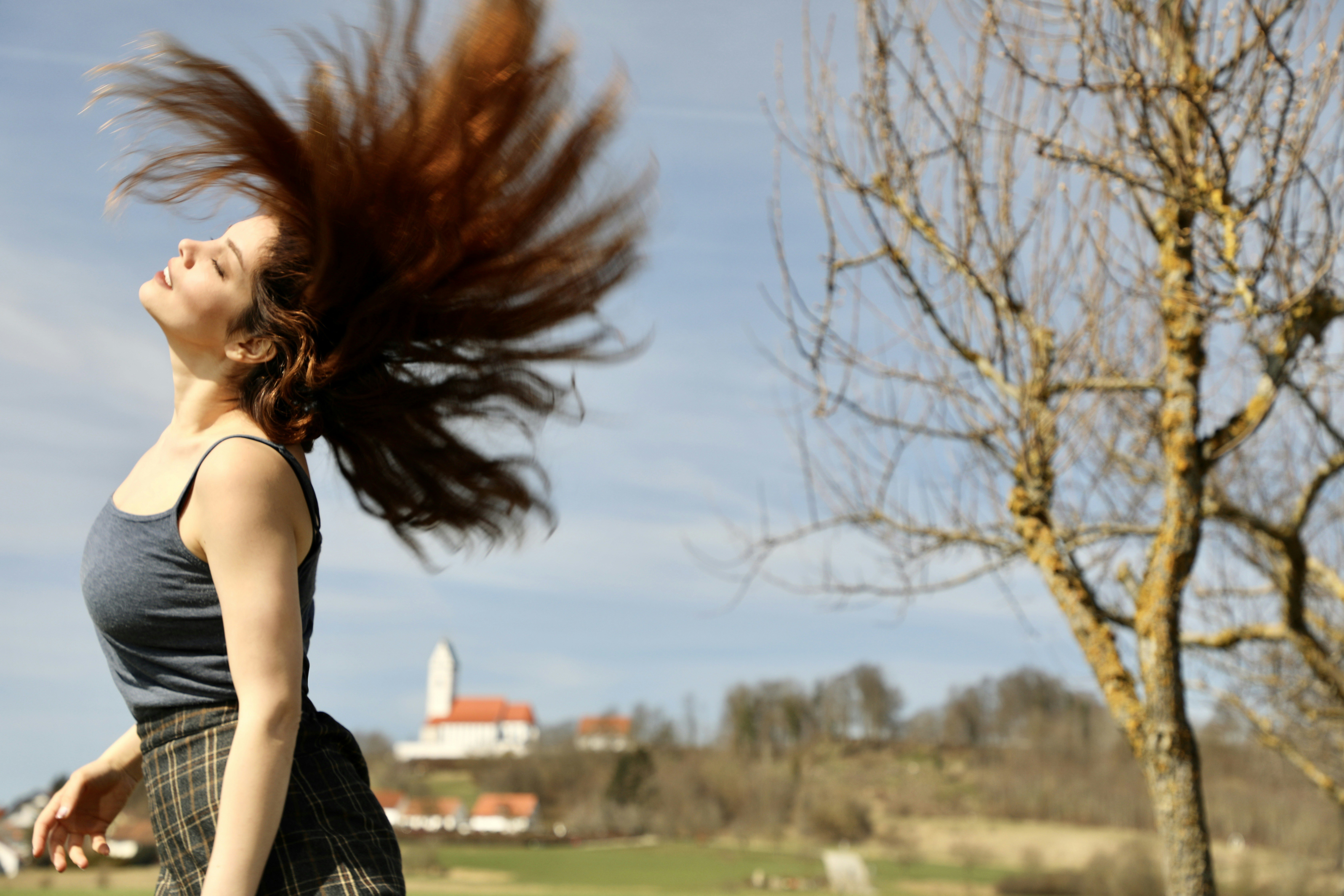 a person with the hair blowing in the wind