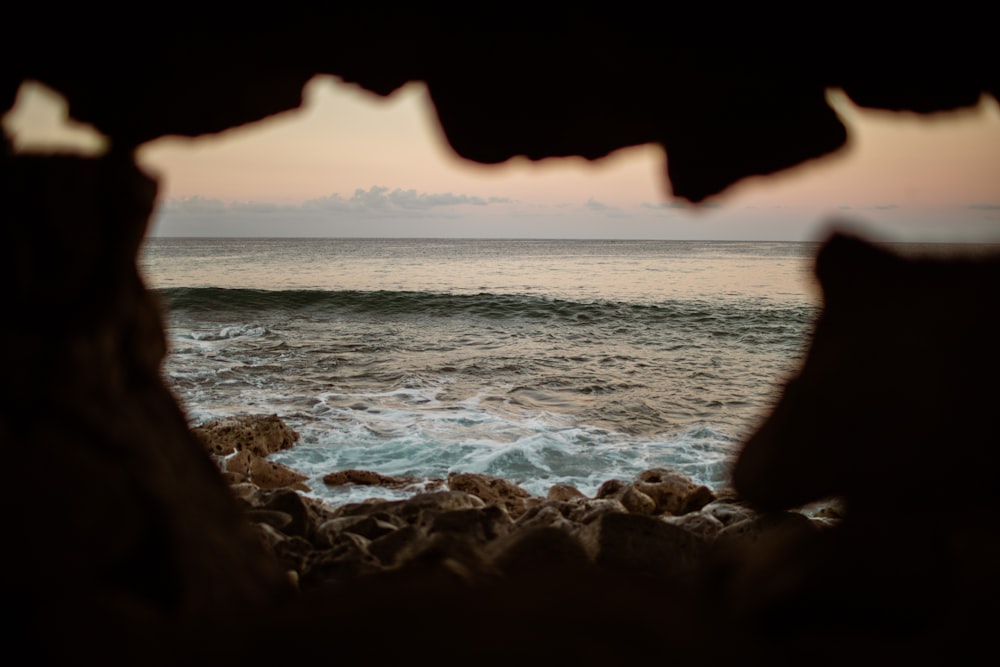 a view of the ocean from a cave