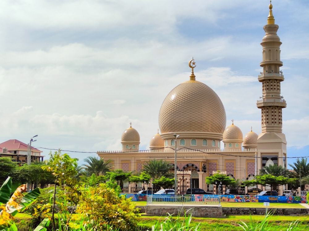 a large building with a gold domed roof and towers