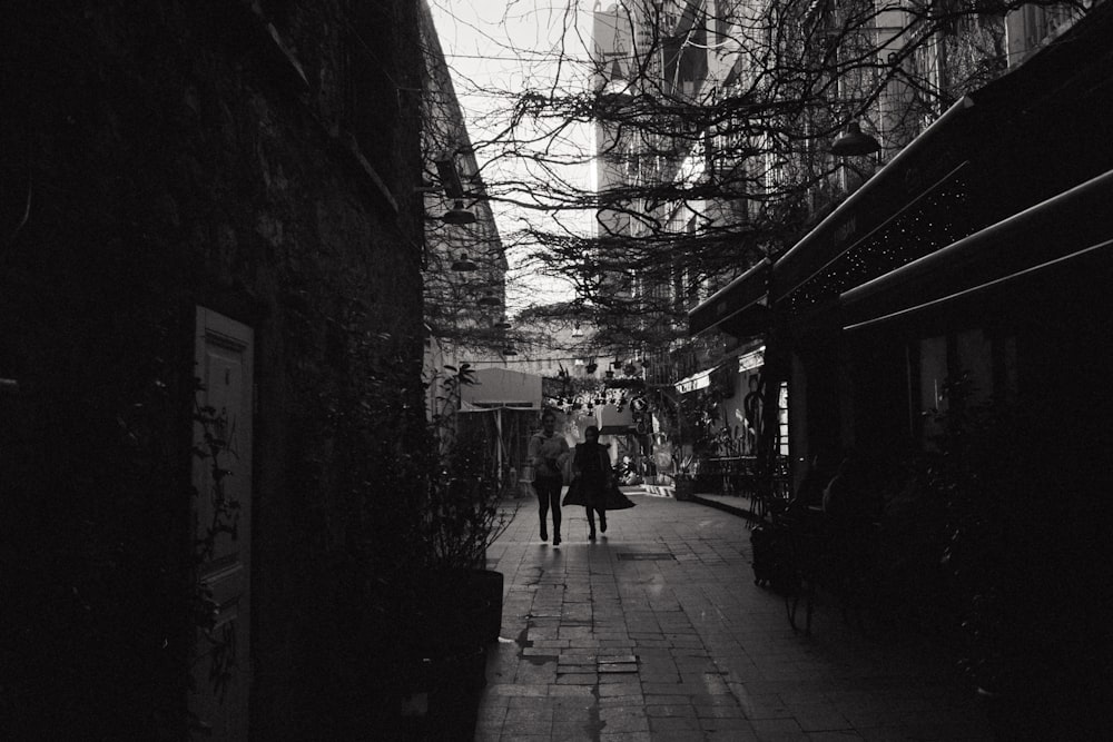 a couple walking down a sidewalk