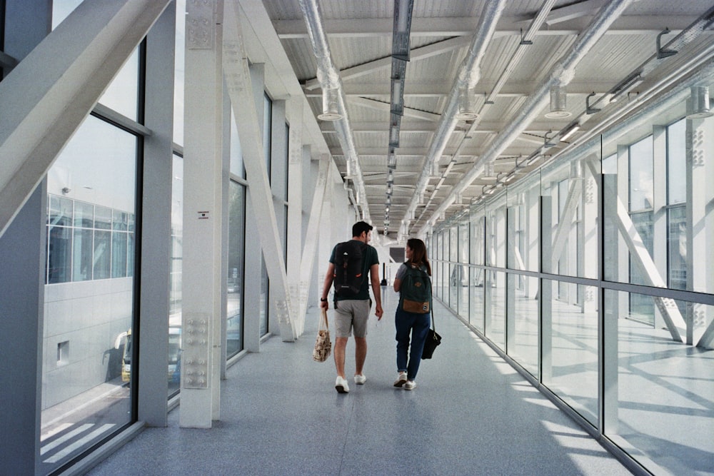 um homem e uma mulher andando por um corredor