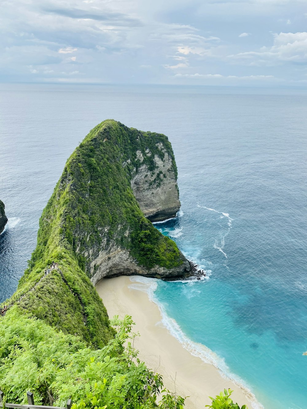 a cliff with a body of water below