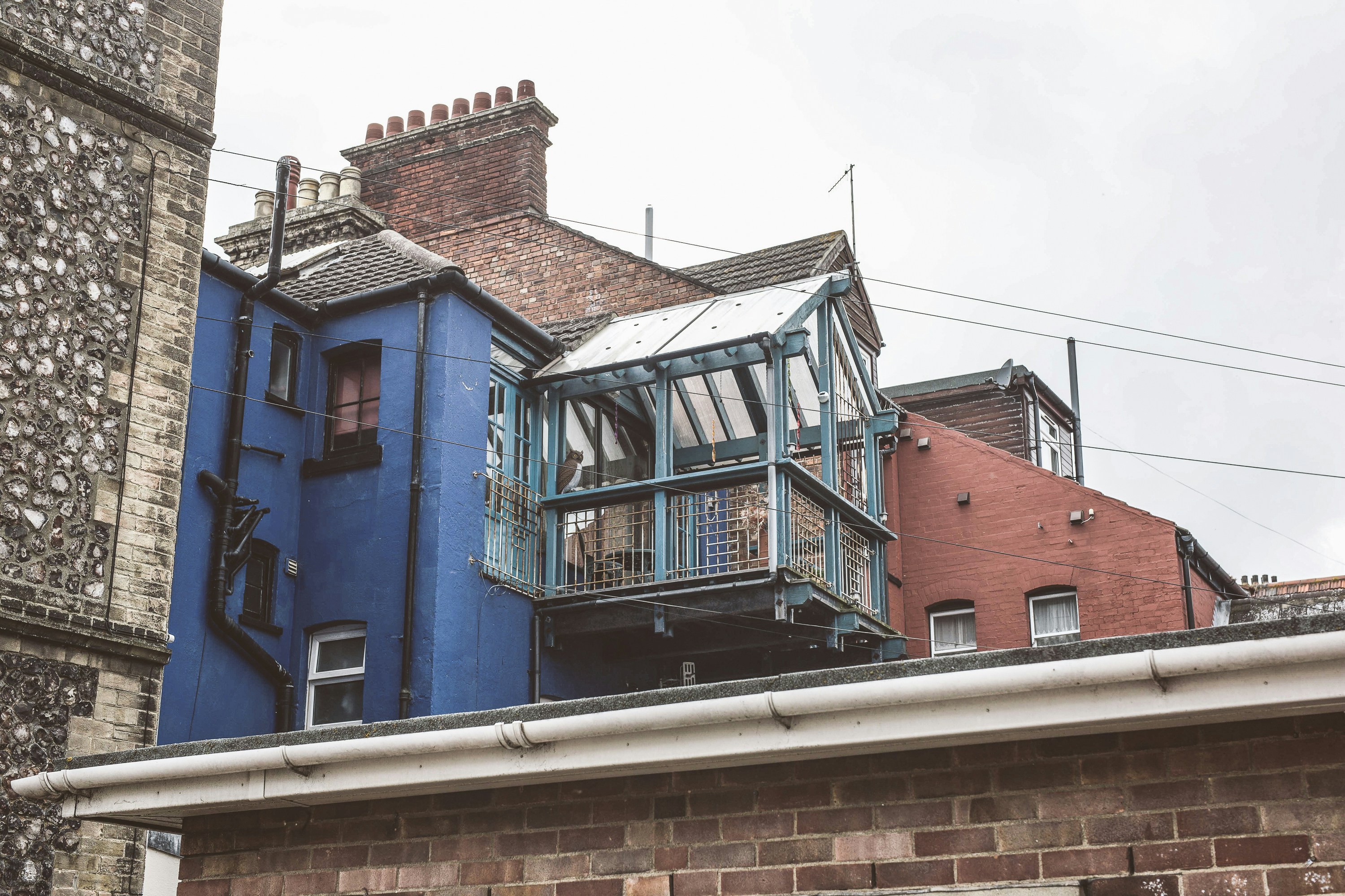 a blue house with a balcony