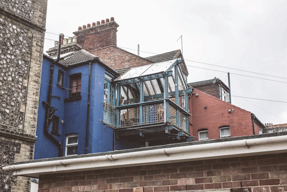 a blue house with a balcony