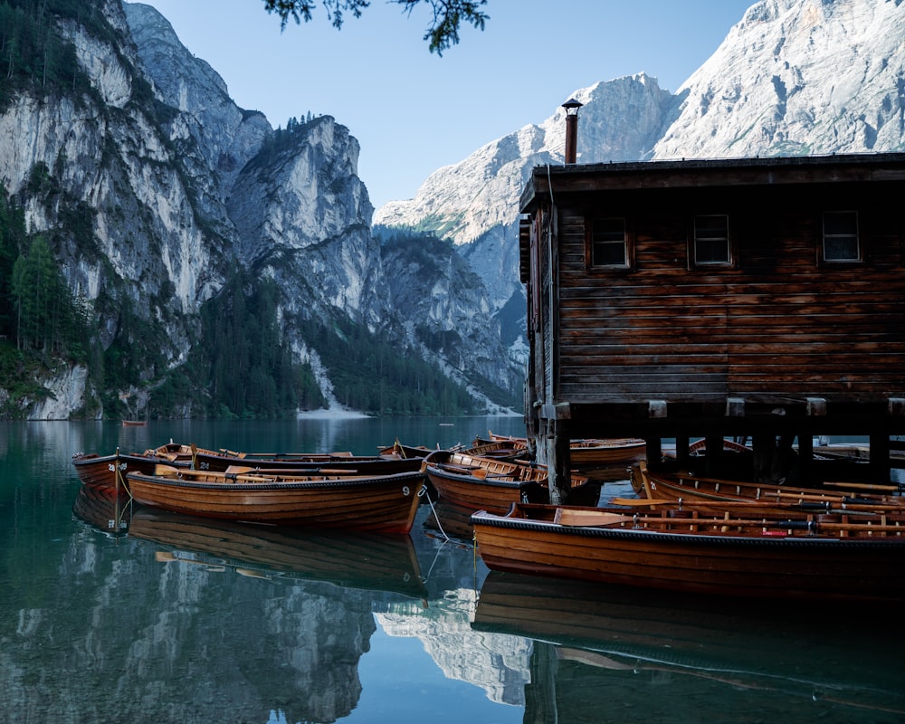 a group of boats sit in a lake