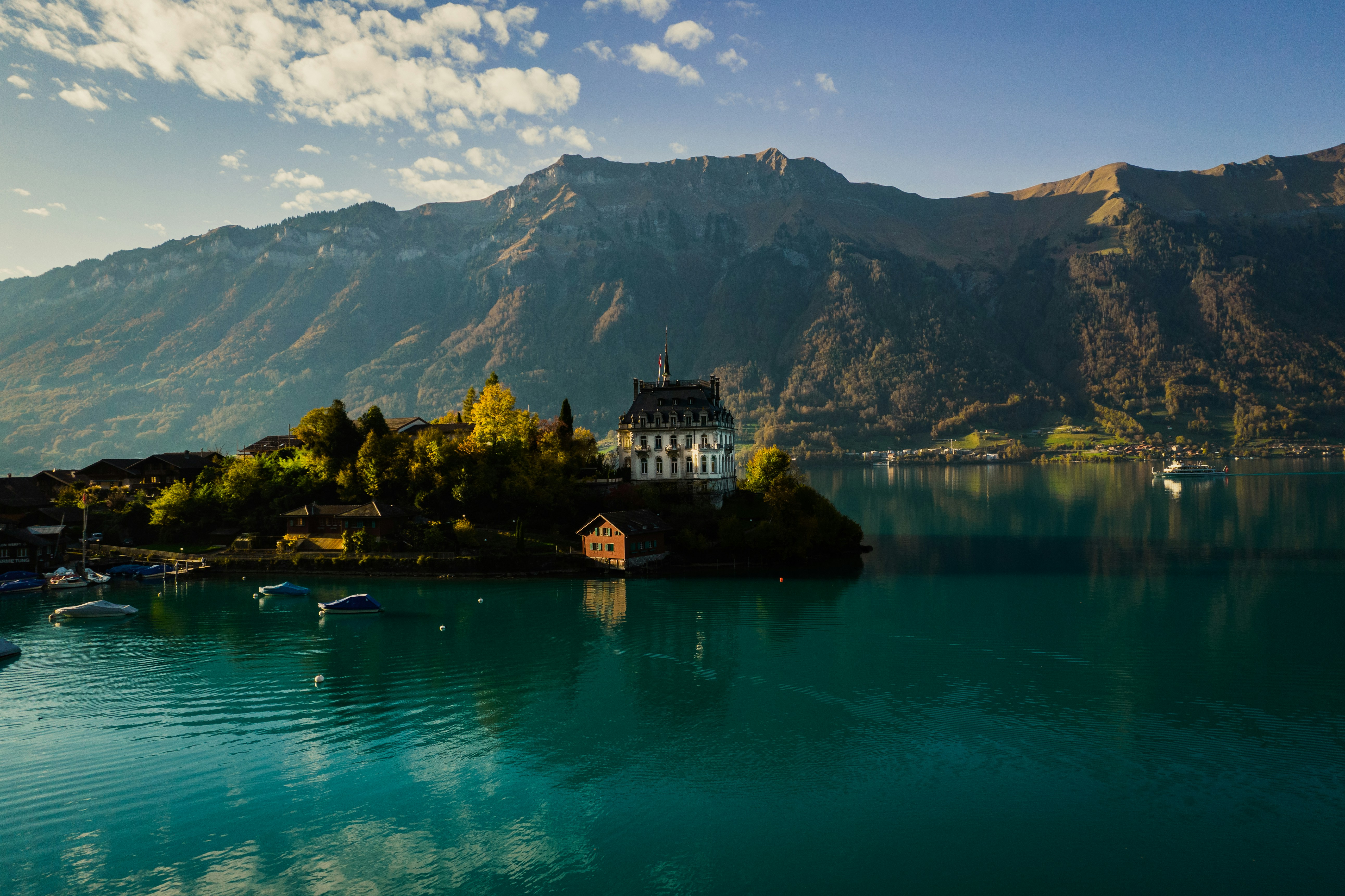 a building on an island, Iseltwald is a pretty village on the shores of Lake Brienz.