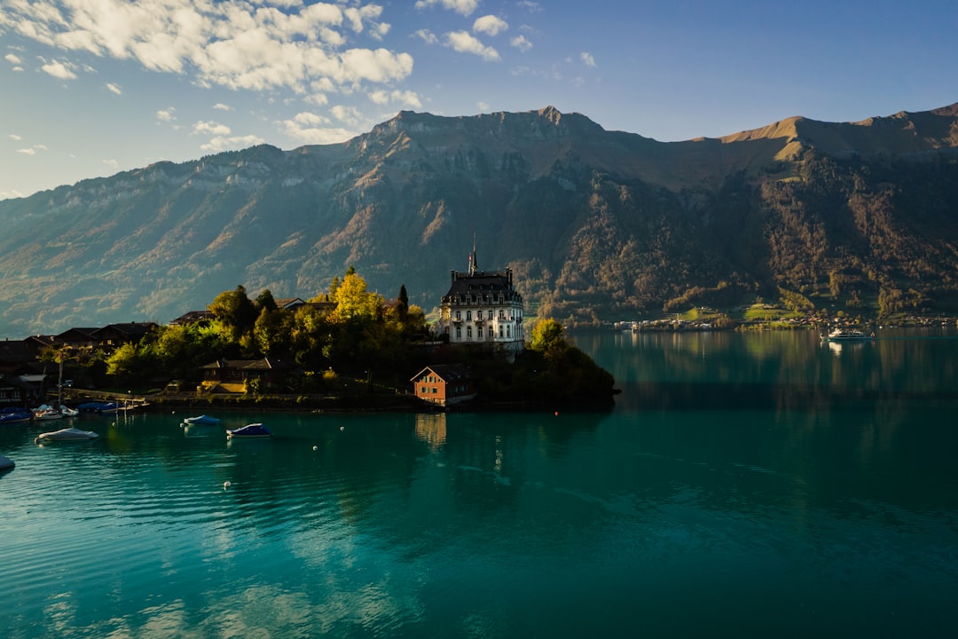 a building on an island, Iseltwald is a pretty village on the shores of Lake Brienz.