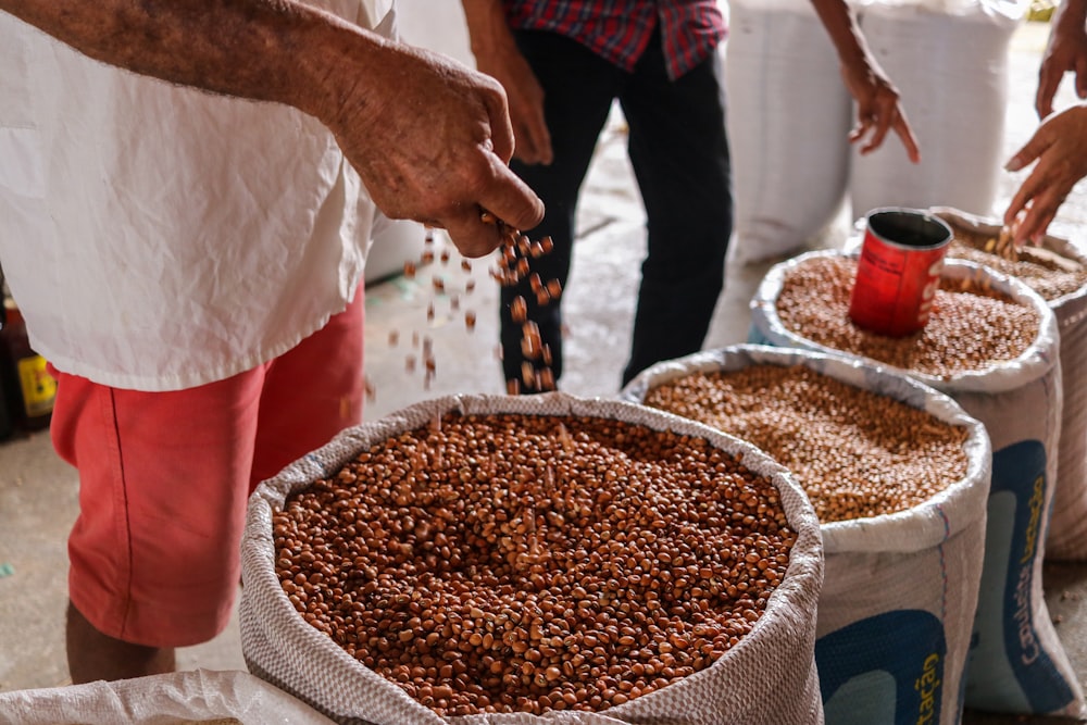 a group of people standing around a table full of food