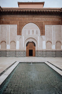 a large building with a fountain in front of it