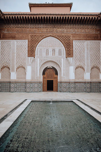 a large building with a fountain in front of it