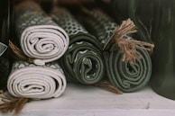 Various sizes of coco fiber mats arranged on a natural wooden surface.