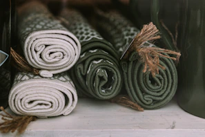 A set of floor mats in coordinating colors placed side by side on a hardwood floor.