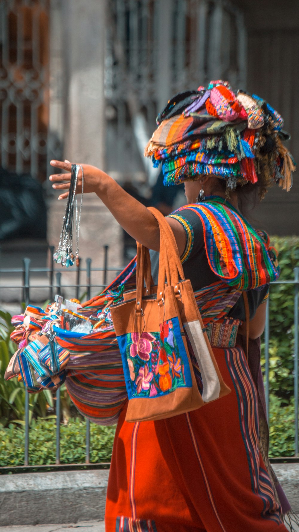 a person in a colorful dress carrying a bag