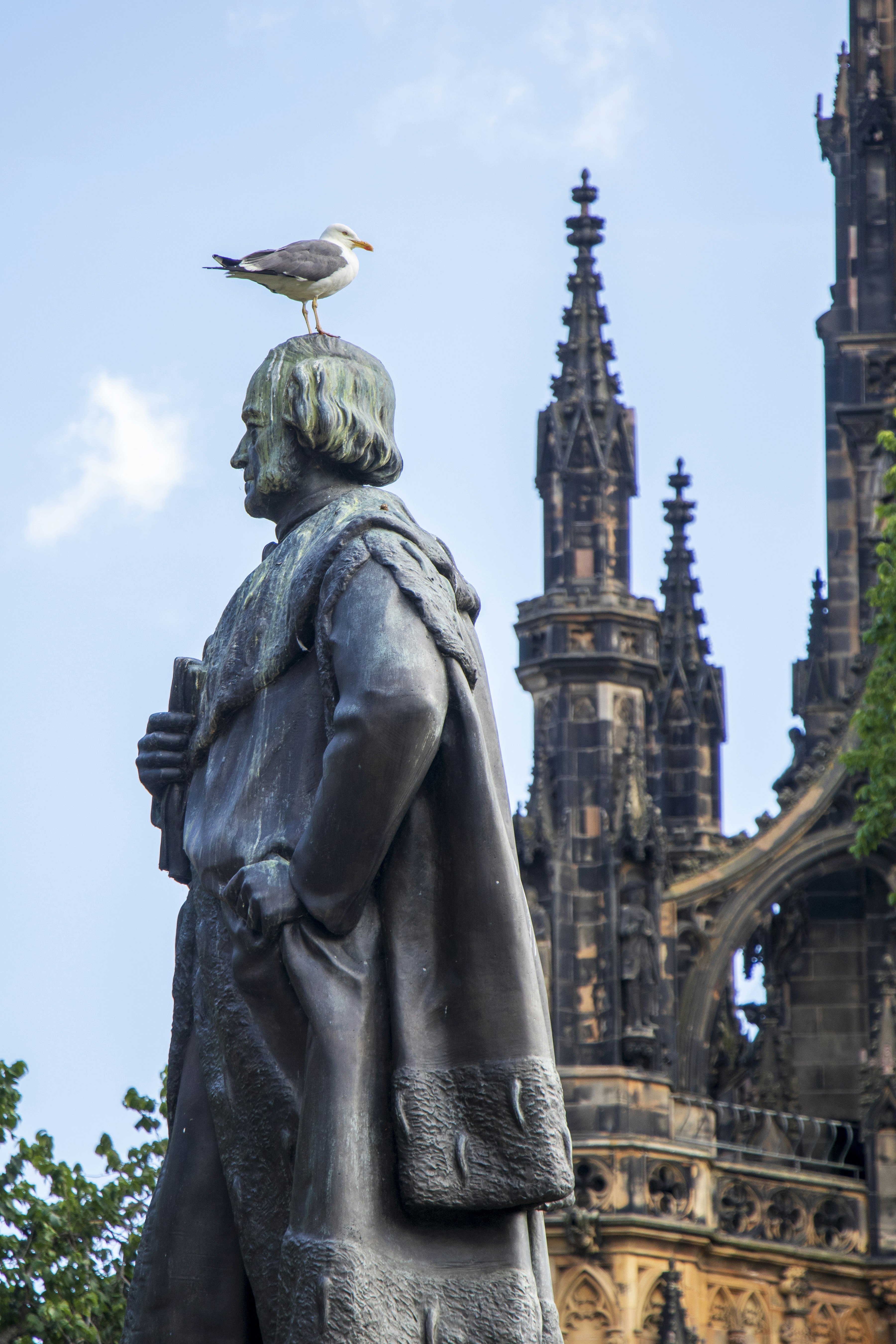 a bird sitting on a statue