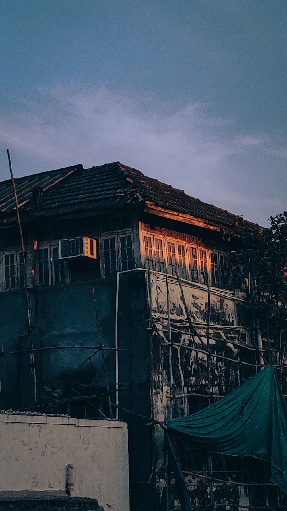 a house with a green tarp