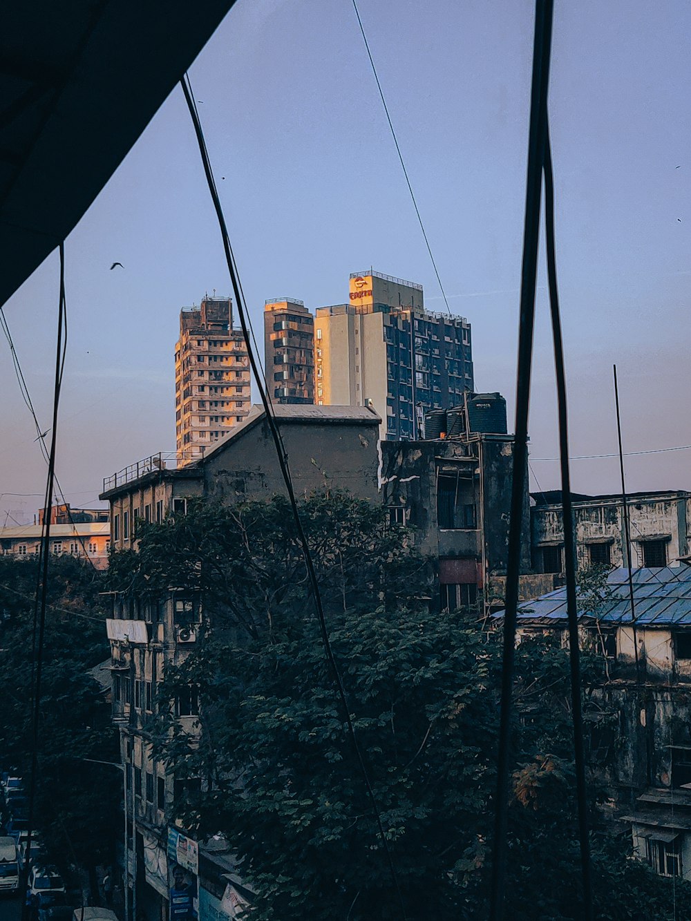 a group of buildings with trees in front of them