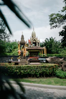 Devotees offering prayers at the Shaktipitha shrine, surrounded by lush greenery.