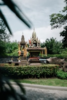 A peaceful garden corner with a small shrine dedicated to Sai Baba, surrounded by blooming jasmine.