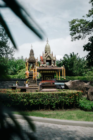 Devotees offering prayers at the Shaktipitha shrine, surrounded by lush greenery.