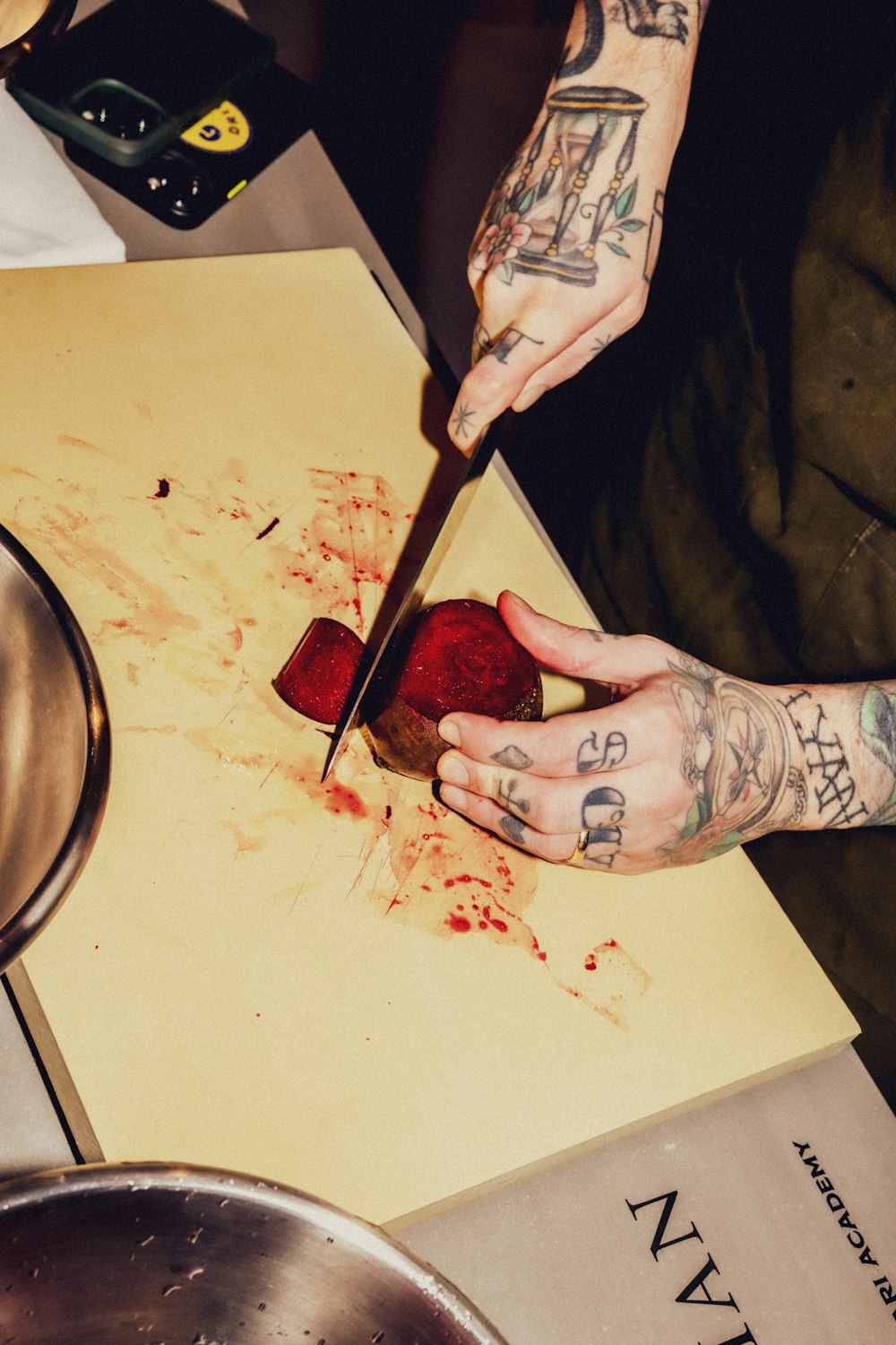 a person cutting a strawberry