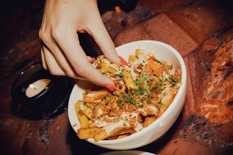 a hand holding a plate of food