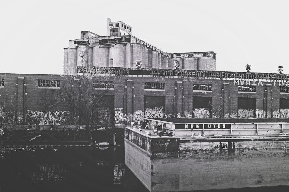 a black and white photo of a building with graffiti on it