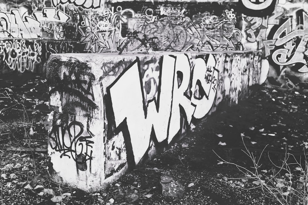 a black and white photo of a building with graffiti on it