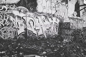 Graffiti art on a brick wall featuring Rebellious Records and hip-hop inspired imagery.