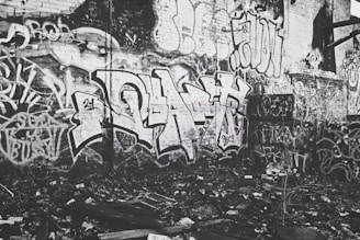 Graffiti art on a brick wall featuring Rebellious Records and hip-hop inspired imagery.