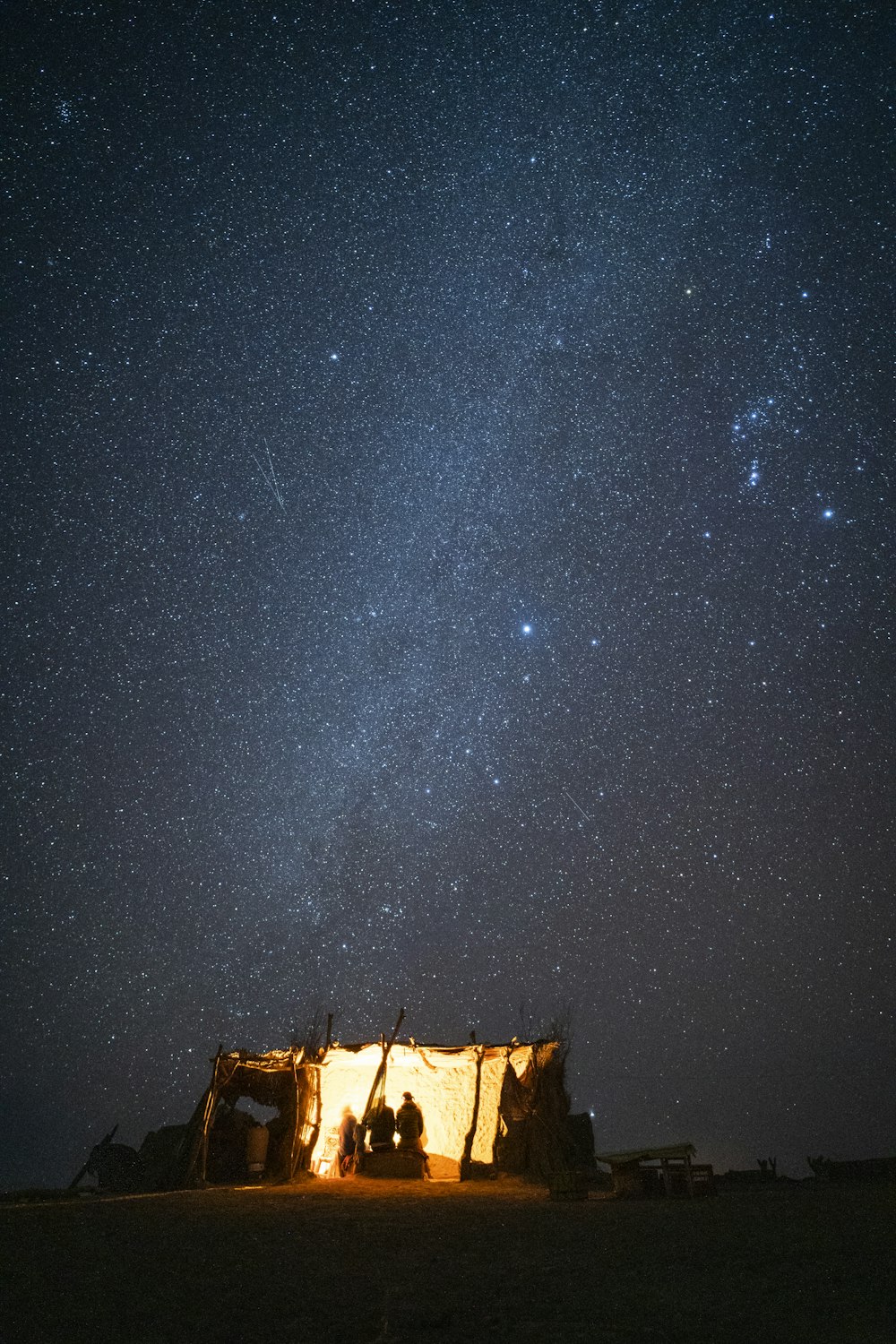 a group of people standing in front of a building under a starry sky