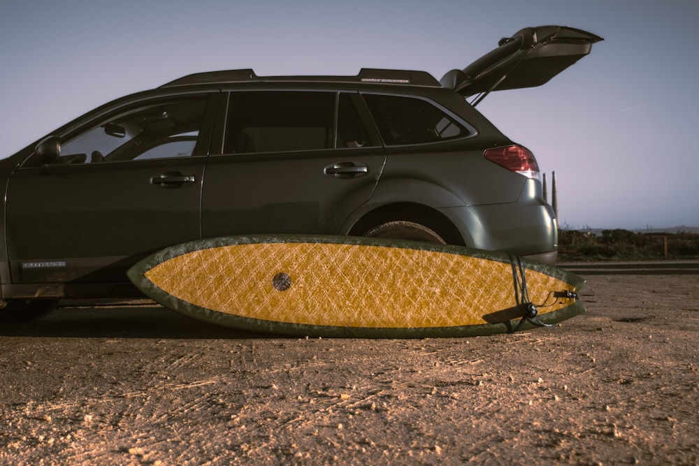 a car with a surfboard on the back